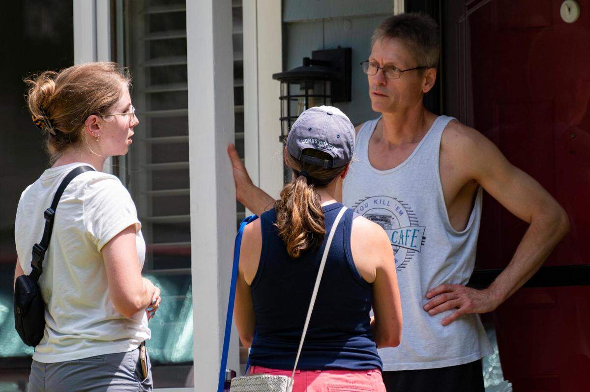 Lindsay Vaughn and Kim Biagioli talk with Bruce Wankum while canvassing neighborhoods in Overland Park on June 18. They urged people to vote “no” on an amendment to the Kansas Constitution that would remove the right to an abortion.