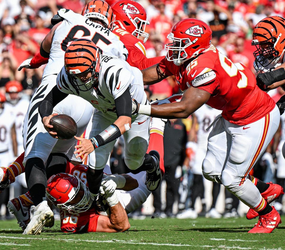 Kansas City Chiefs defensive end George Karlaftis (56) and defensive tackle Chris Jones (95) sack Cincinnati Bengals quarterback Joe Burrow (9) in the second quarter Sunday, Sept. 15, 2024, at GEHA Field at Arrowhead Stadium.