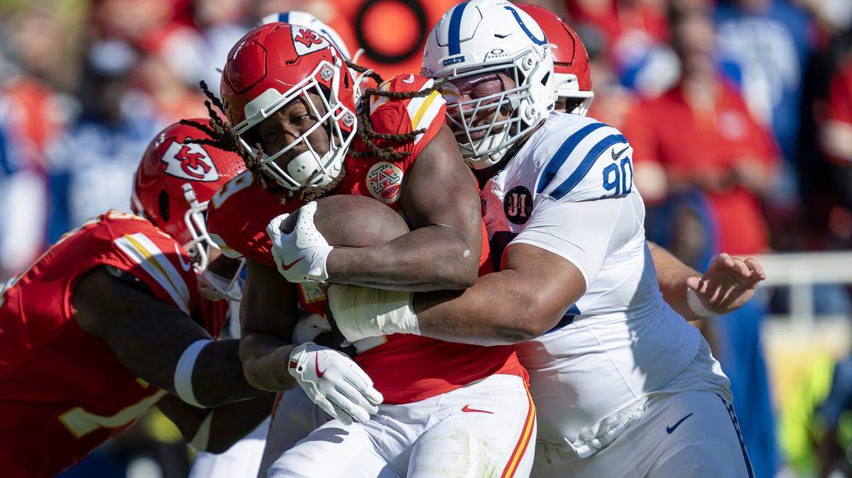 Indianapolis Colts defensive tackle Grover Stewart (90) goes after Kansas City Chiefs running back Kareem Hunt (29) in the first half on Sunday, Nov. 23, 2025 at GEHA Field at Arrowhead Stadium in Kansas City.