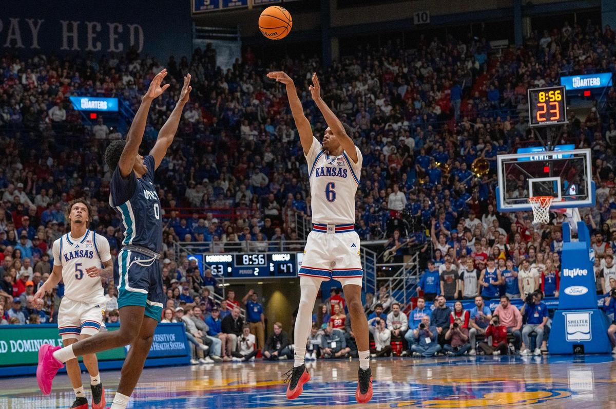 Kansas Jayhawks guard Rylan Griffen (6) releases a shot as UNC Wilmington guard Bo Montgomery (0) blocks in the second half on Tuesday, Nov. 19, 2024, at Allen Fieldhouse.