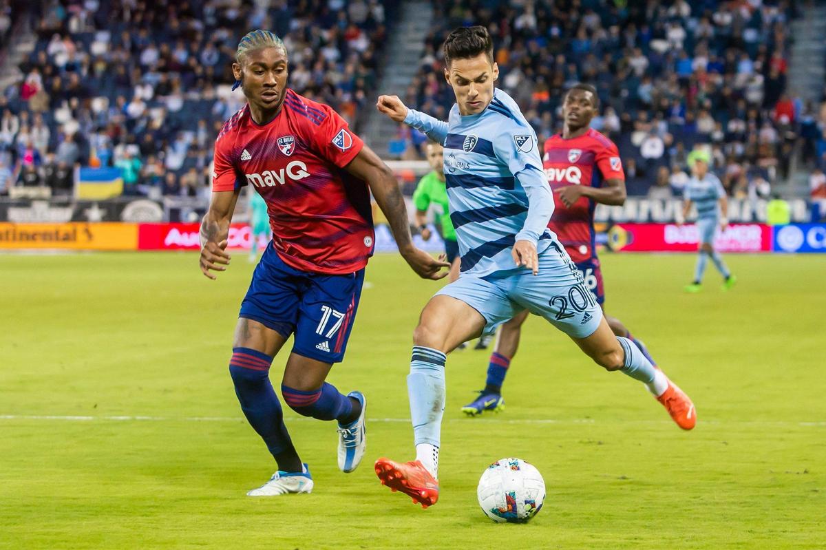 Sporting Kansas City forward Daniel Salloi, right, crosses the ball ahead of FC Dallas defender Nkosi Tafari during their teams’ April 30 match at Children’s Mercy Park in Kansas City, Kansas.