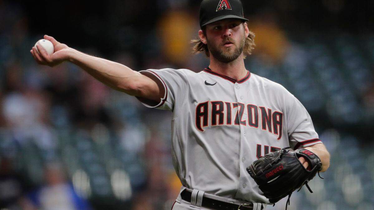 Arizona Diamondbacks’ Matt Peacock throws to first after fielding a bunt during the fourth inning of a baseball game against the Milwaukee Brewers Friday, June 4, 2021, in Milwaukee. (AP Photo/Aaron Gash)