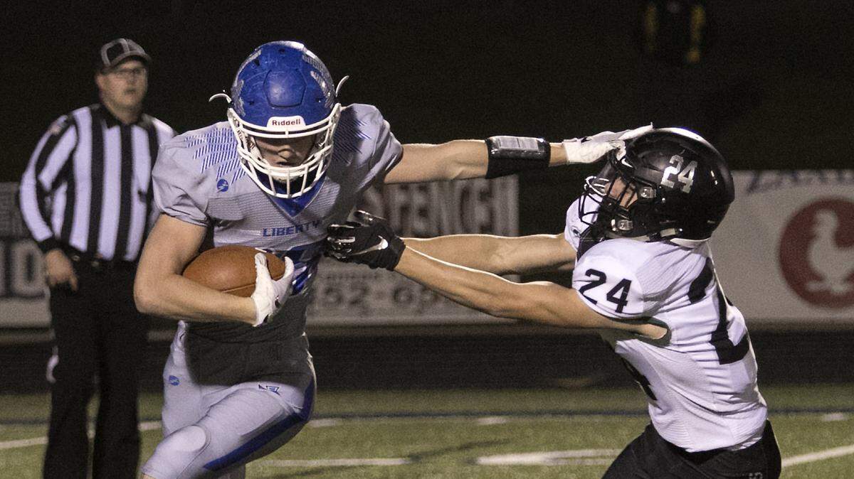 Liberty’s Hayden West used a stiff arm against Staley’s David Lewis in Friday’s game at Liberty.