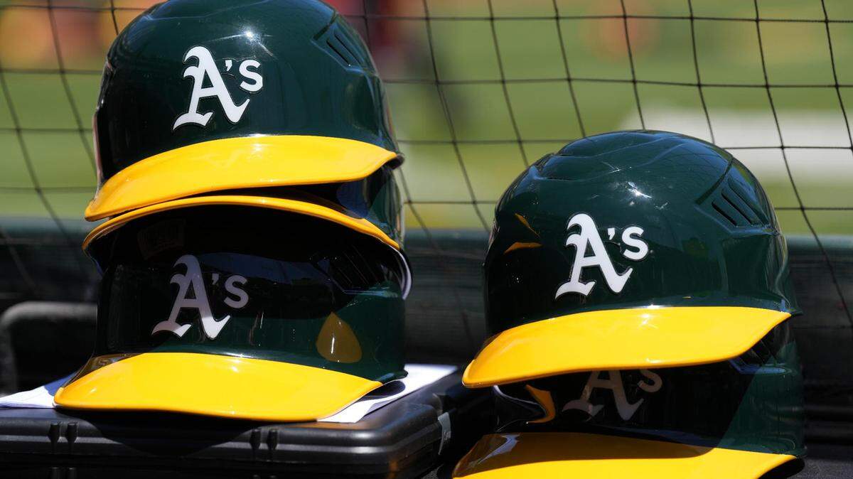 May 29, 2022; Oakland, California, USA; Oakland Athletics helmets are stacked near the field before the game against the Texas Rangers at RingCentral Coliseum. Mandatory Credit: Darren Yamashita-USA TODAY Sports