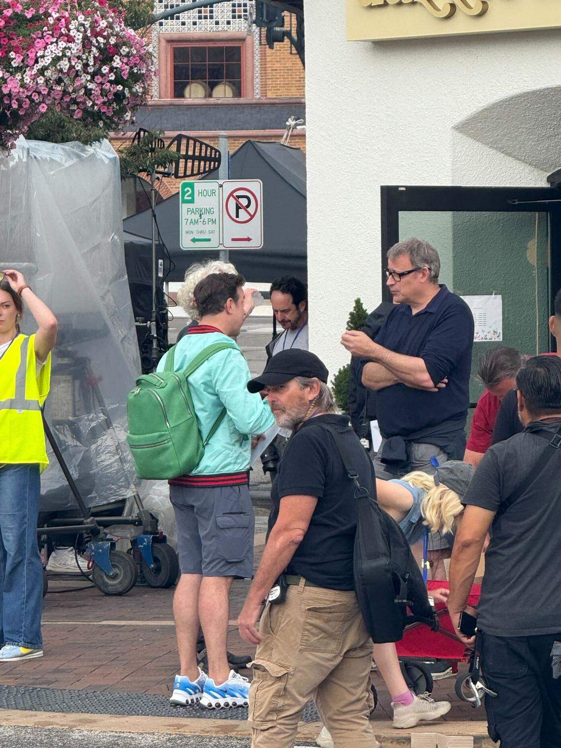 Jason Sudeikis, wearing the green backpack, on the set of “Ted Lasso” Monday afternoon on the Country Club Plaza.