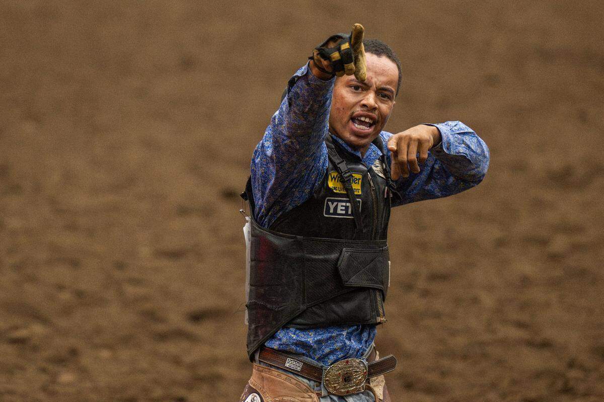 Lamarr Hankins celebrates after jumping off his horse during the bronc riding competition at the Black Rodeo USA Saturday at Hale Arena.