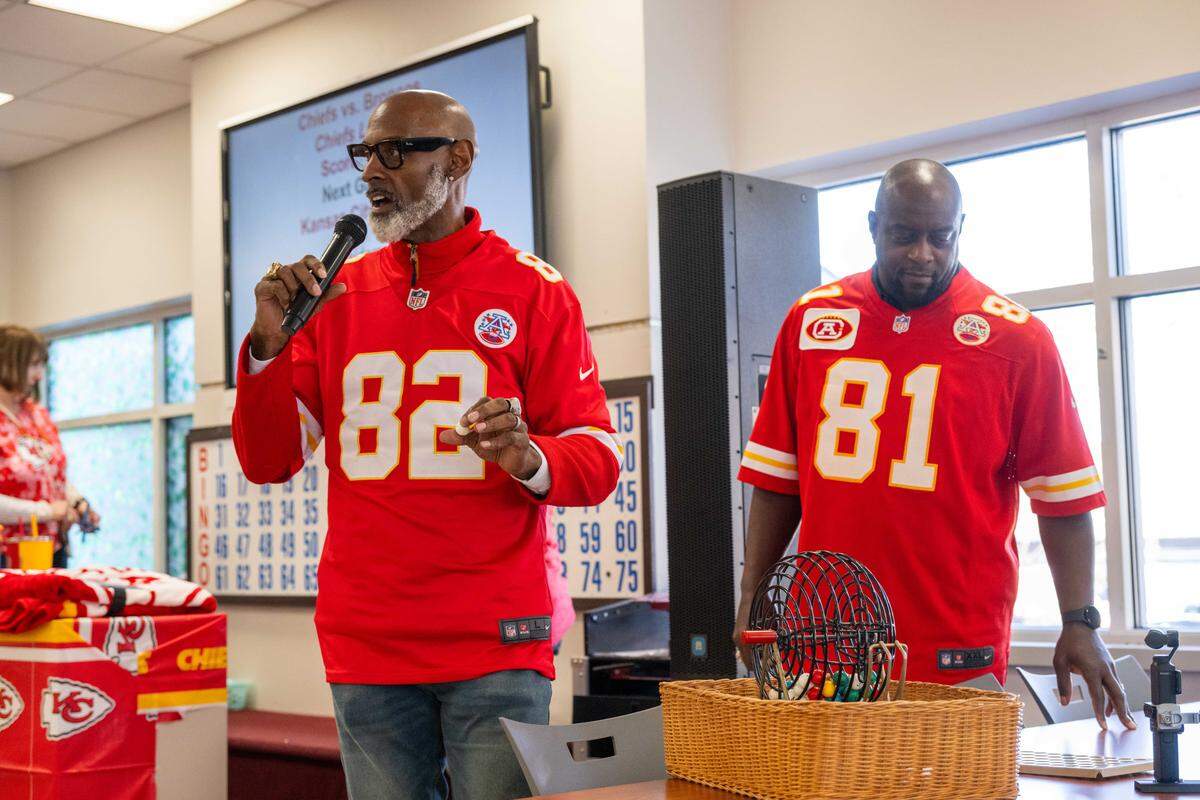 Former Kansas City Chiefs players Tim Barnett and Chris Penn call out numbers during a round of bingo at the Don Bosco Senior Center on Tuesday, December 30, 2025, in Kansas City.