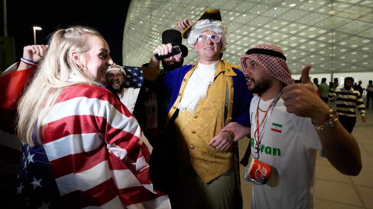 An Iran soccer fan talks with U.S. Soccer fans ahead of the World Cup group B soccer match between Iran and the United States at the Al Thumama Stadium in Doha, Qatar, Tuesday, Nov. 29, 2022.