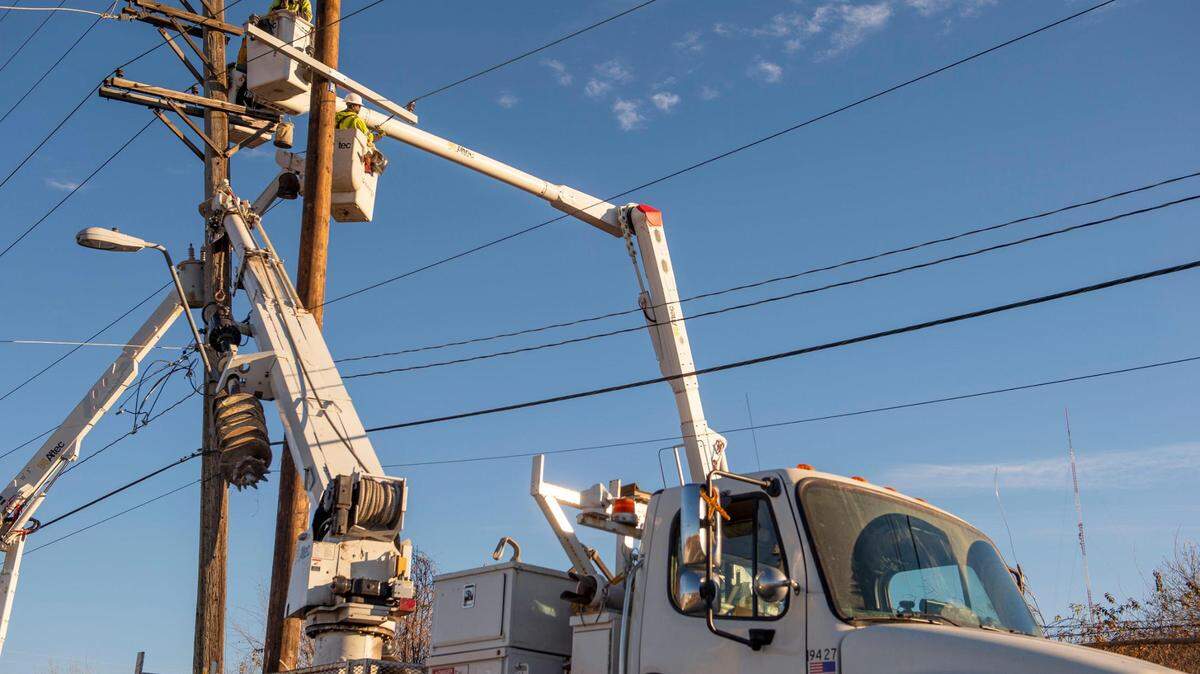 Strong to severe storms rolled through the Kansas City area overnight leaving thousands without power Wednesday morning. In this file photo, Evergy crew members repair a damaged electricity pole on West 25th Street in Kansas City on Dec. 16, 2021.