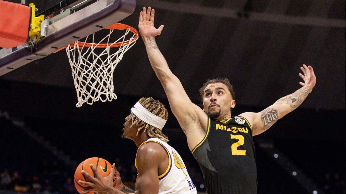 LSU Tigers guard Adam Miller, left, drives to the basket against Missouri’s Tre Gomillion during Wednesday’s game at the Pete Maravich Assembly Center in Baton Rouge, La.