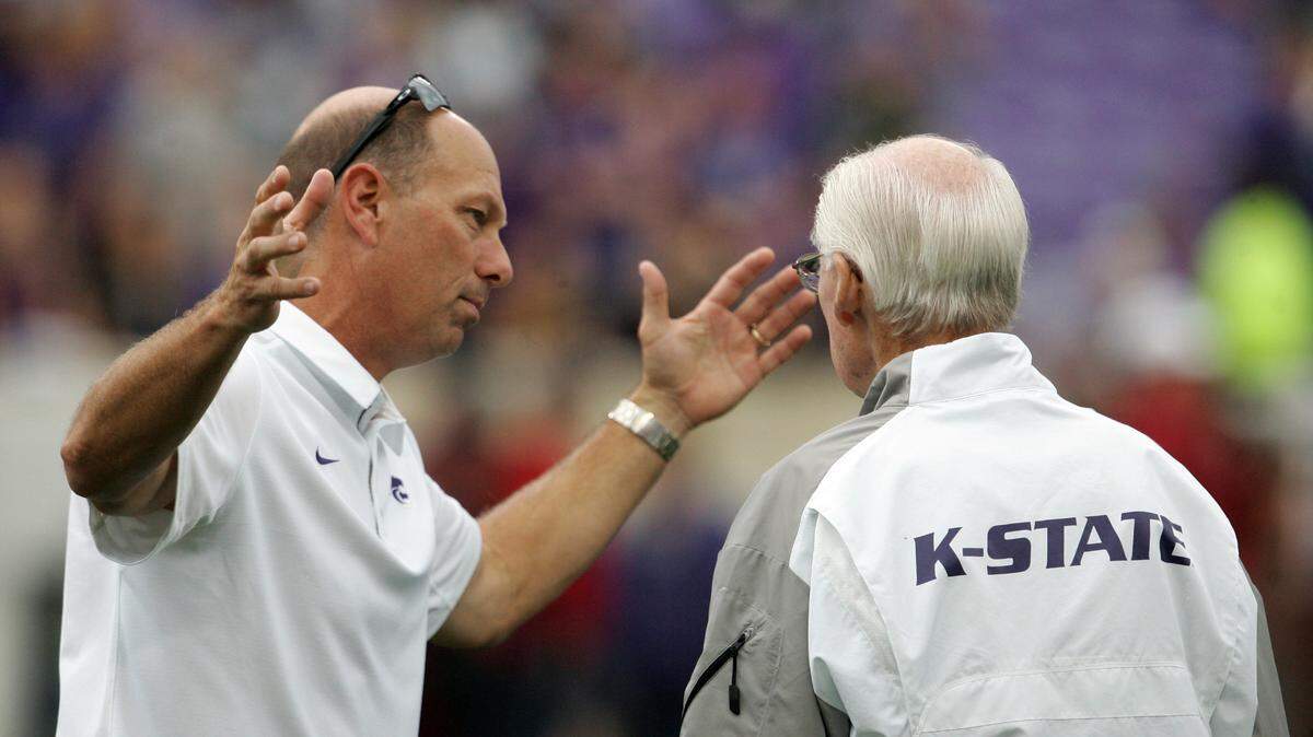 Kansas State Wildcats assistant head coach and special teams coach Sean Snyder (left) visits with head coach Bill Snyder before the start of a game against the Oklahoma Sooners at Bill Snyder Family Stadium on Oct. 21, 2017.
