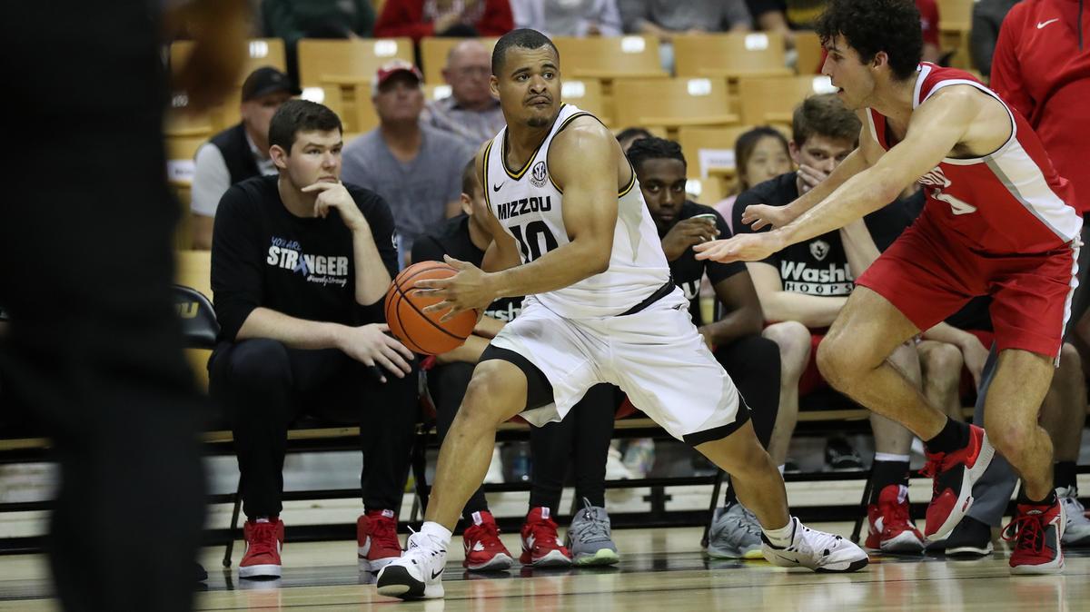 Mizzou’s Nick Honor looks for options with the basketball Thursday night against Washington University at Mizzou Arena. The Tigers won the preseason game 89-61.
