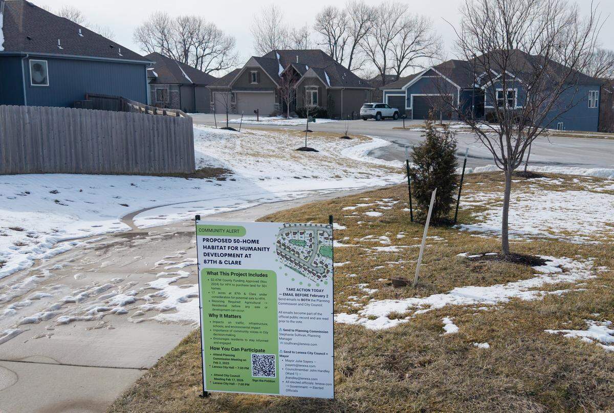 A sign alerts residents to a hearing for a proposed 50-home Habitat for Humanity development near 86th Terrace and Clare Road in Lenexa. 