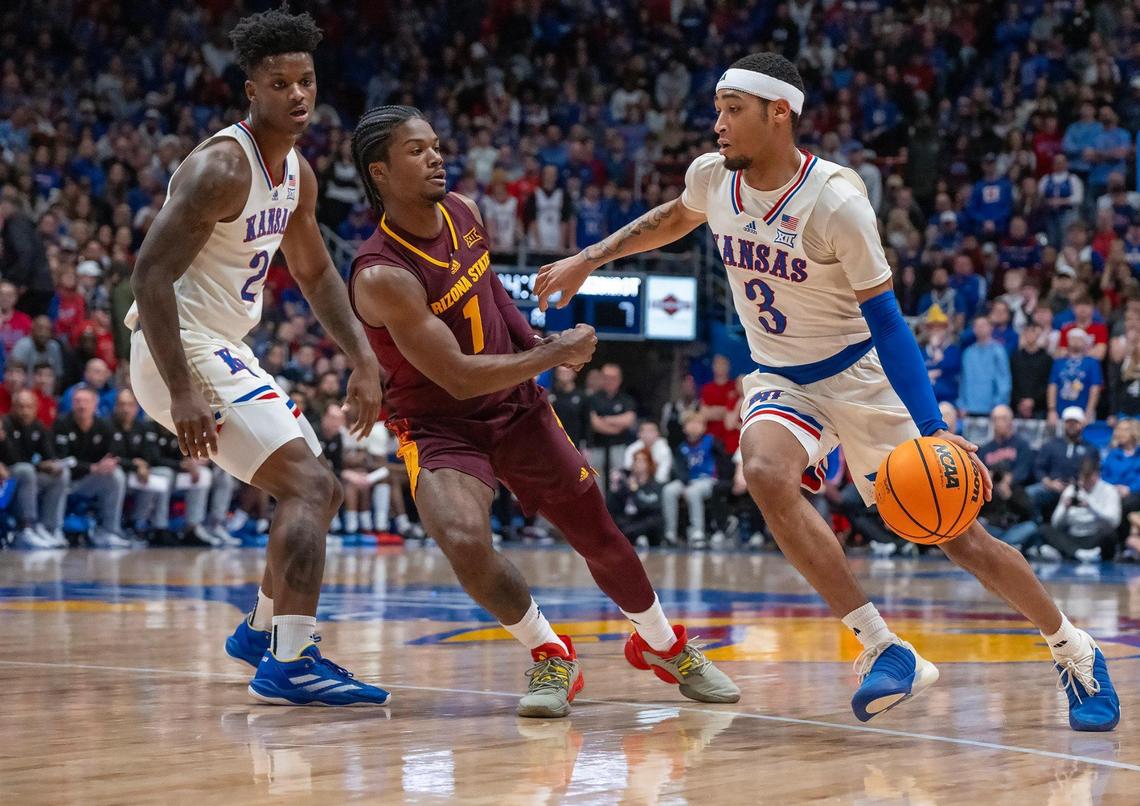 Kansas Jayhawks guard Dajuan Harris Jr. (No. 3) drives around Arizona State Sun Devils guard Alston Mason during a college basketball game at Allen Fieldhouse on Wednesday, Jan. 8, 2025, in Lawrence, Kansas.