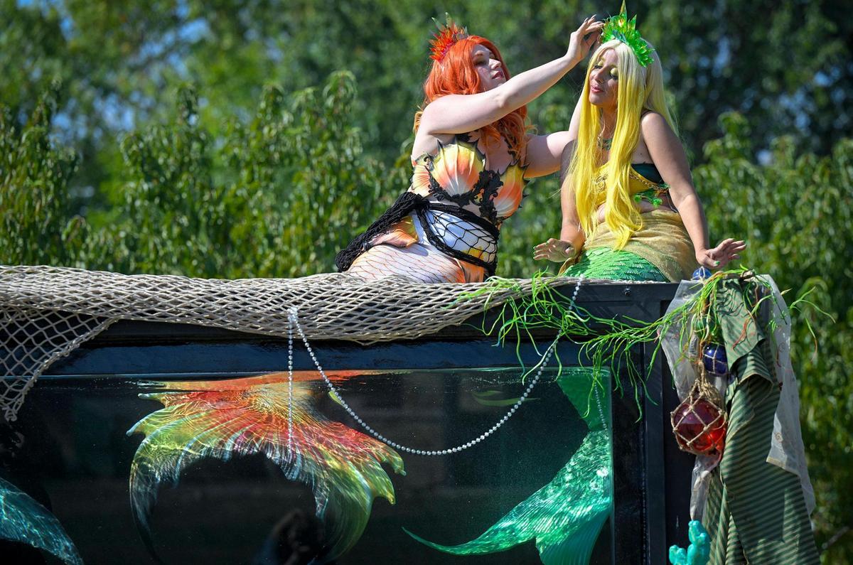 Watkins, left, adjusts the tiara of Mermaid Citrise, Nicole Loudon, during the video shoot for Watkins’ company.