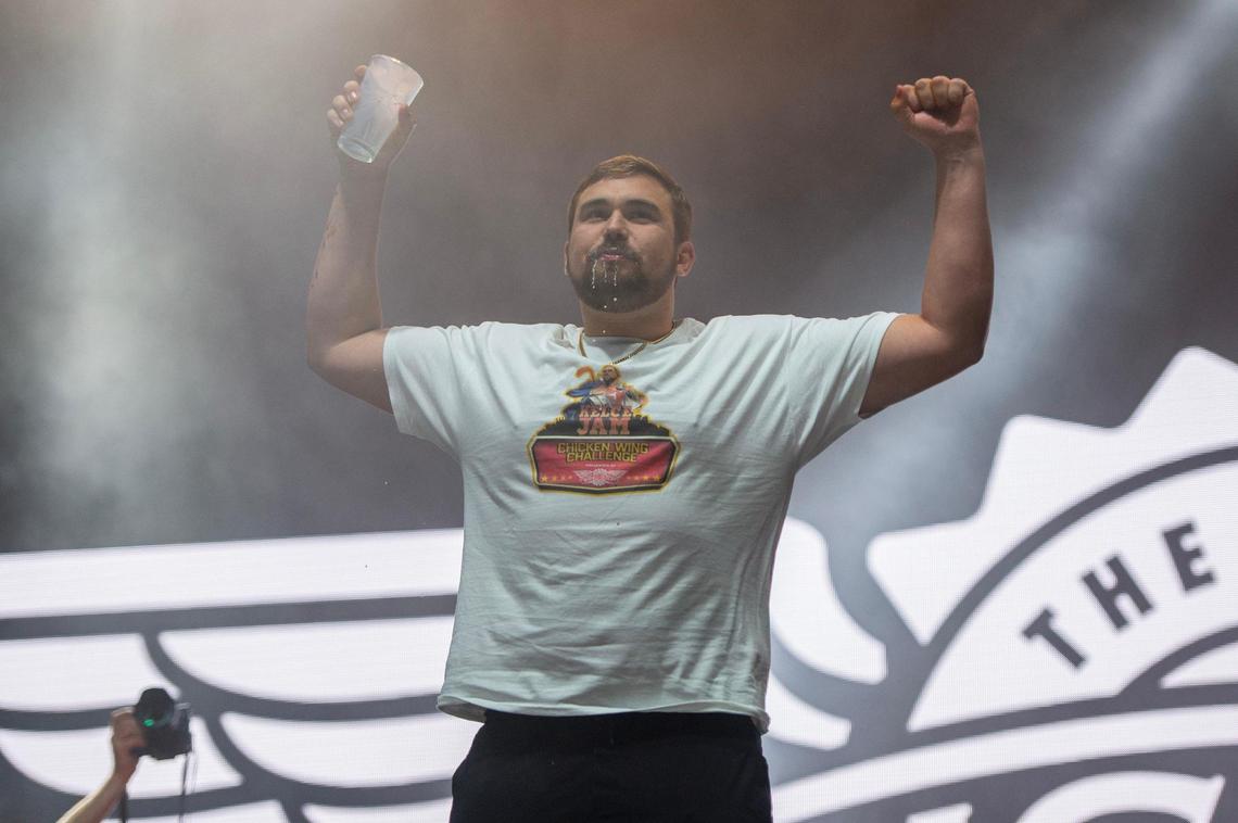 Ryan Gillum chugs down milk after winning the Wingstop Chicken Wing Challenge during Kelce Jam at the Azura Amphitheater on Friday, April 28, 2023, in Bonner Springs.