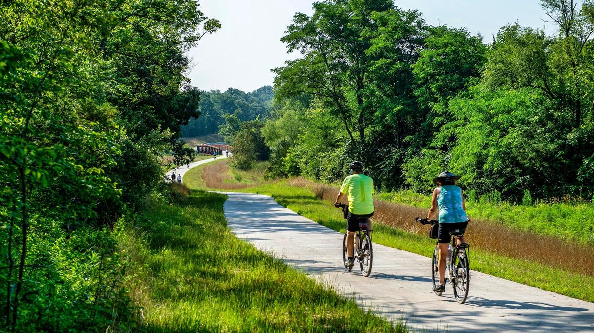 People ride bikes and walk on the Rock Island Trail head, Monday, July 5, 2021 in Kansas City. A ceremony for the completion of the Rock Island Trail will be held Saturday, July 10, 2021 at 10 in the morning at the northernmost trailhead in parking lot L of the Truman Sports Complex in Kansas City.