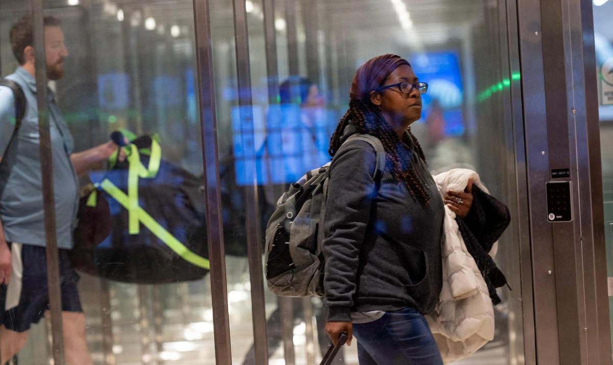 Travelers exit the secured area after arriving at KCI Airport in November 2023 in Kansas City.