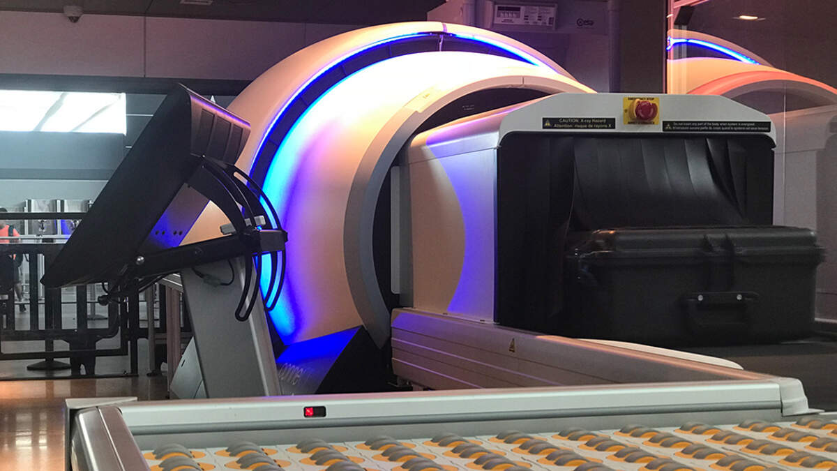 New, smaller CT luggage scanners might mean checking your bags and paying luggage fees.