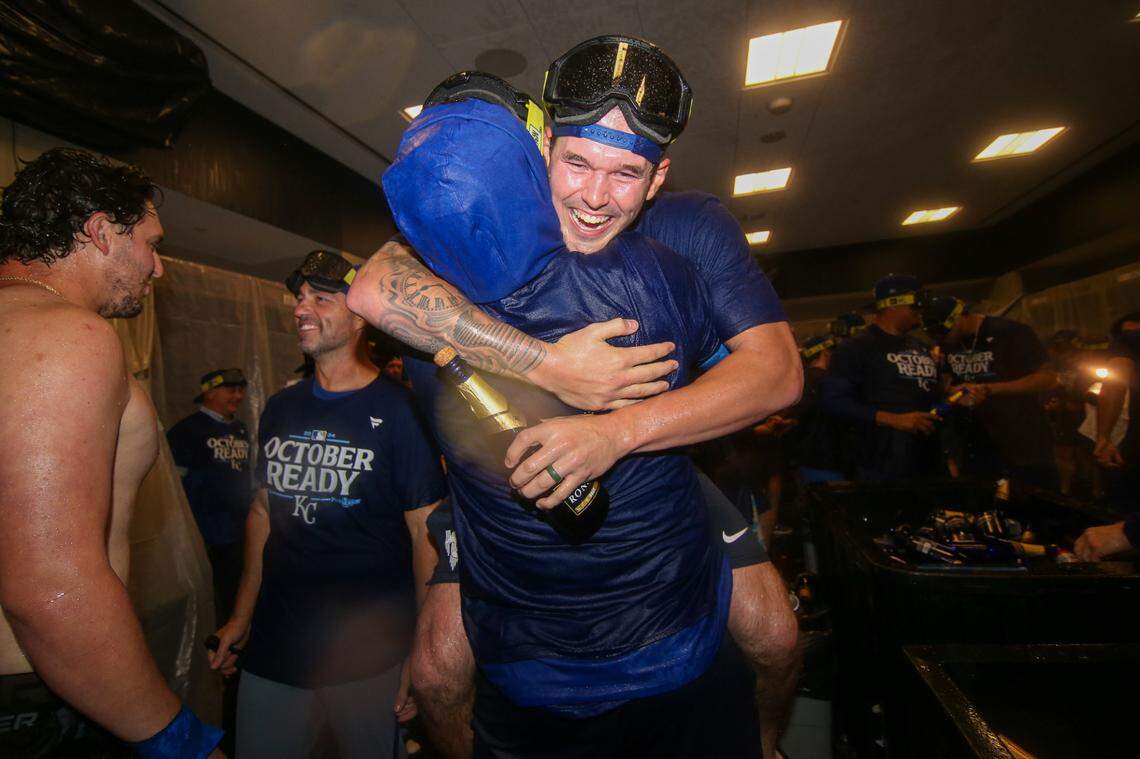 Kansas City Royals starting pitcher Cole Ragans (55) is held up by catcher Salvador Perez (13) as they celebrate after clinching a wild card playoff birth after a game against the Atlanta Braves at Truist Park.