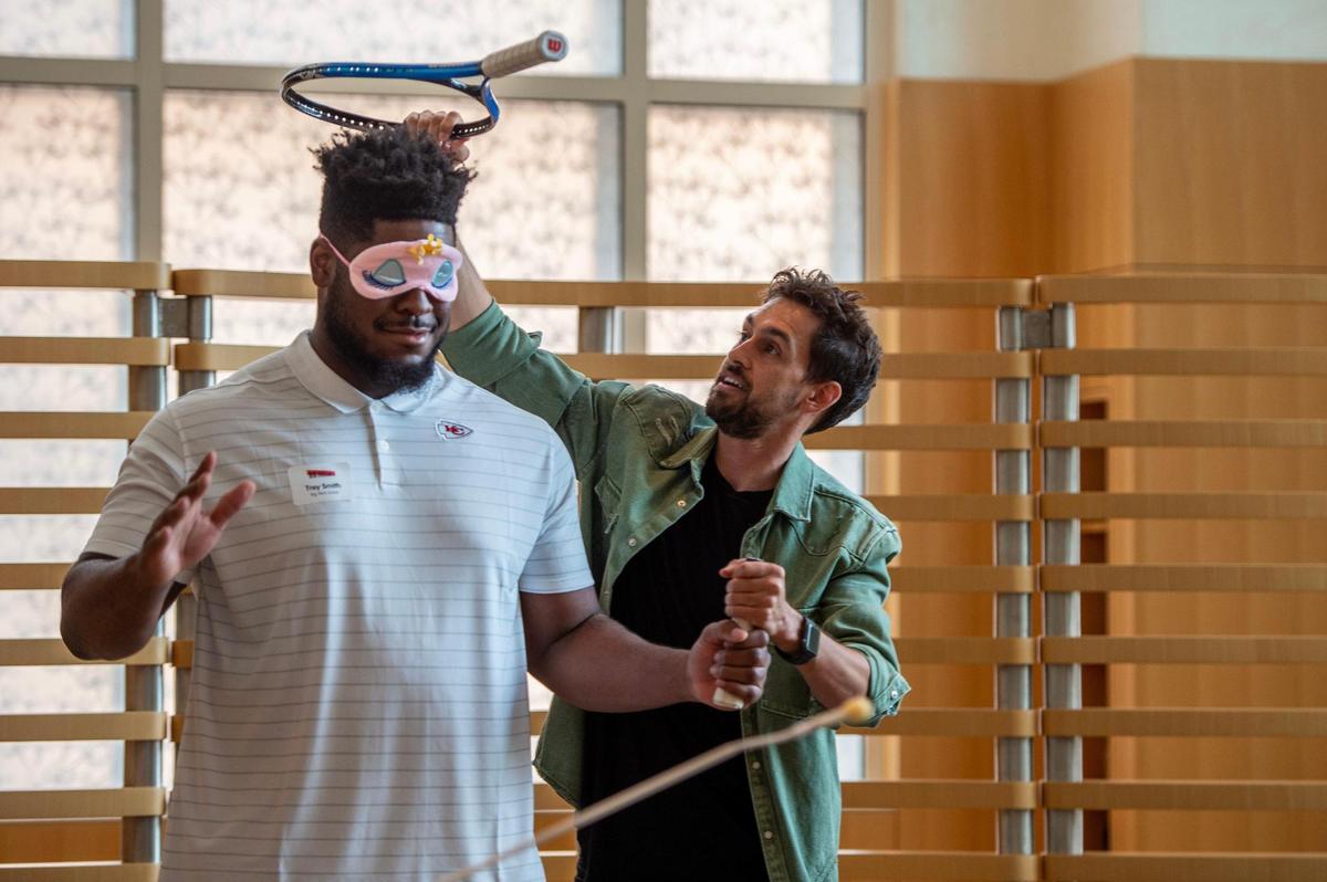 Kansas City Chiefs lineman Trey Smith, left, volunteered to be part of a trick performed by magician Blake Vogt at Children’s Mercy Hospital in 2023. Vogt has entertained pediatric patients ahead of the Big Slick Celebrity Weekend for several years.
