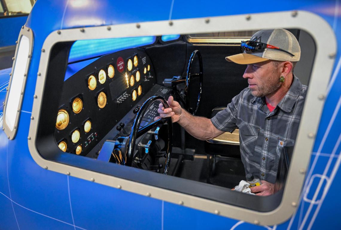 Jason Heath, a builder and installer with Dimensional Innovations, polishes up the a full-size replica of Muriel’s cockpit exhibit ahead of the opening of the Amelia Earhart Hangar Museum on Friday in Atchison. Dimensional Innovations of Overland Park designed, built and installed all of the exhibits in the new museum.