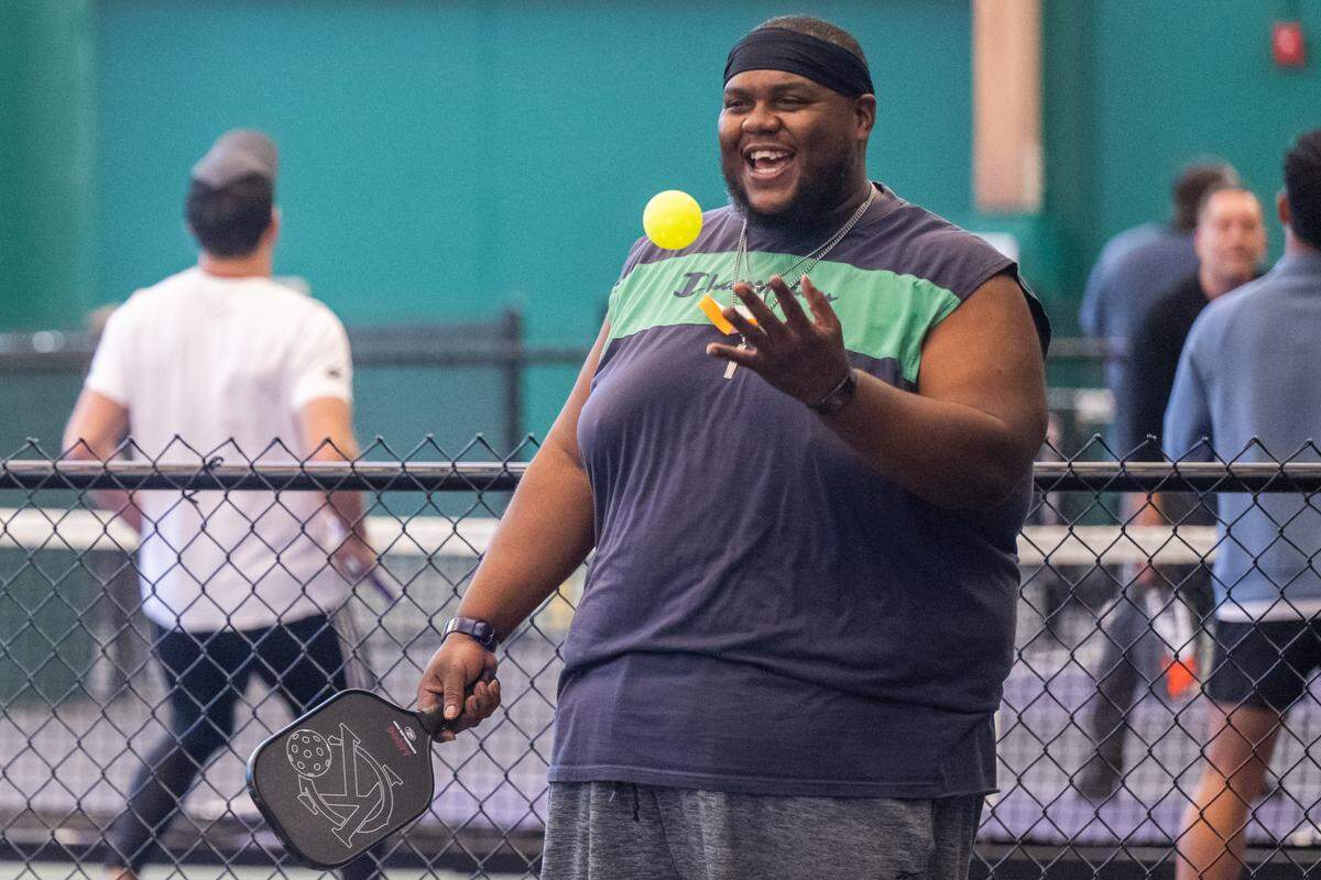 Justin Johnson prepares to serve during a meeting of the Black Pickleball Club at SW19 at the Stadium, on Sunday, February 22, 2026, in Kansas City. The club, started by Brandan Jackson, hosts weekly meetups every Sunday as a space for Black people to participate in pickleball.