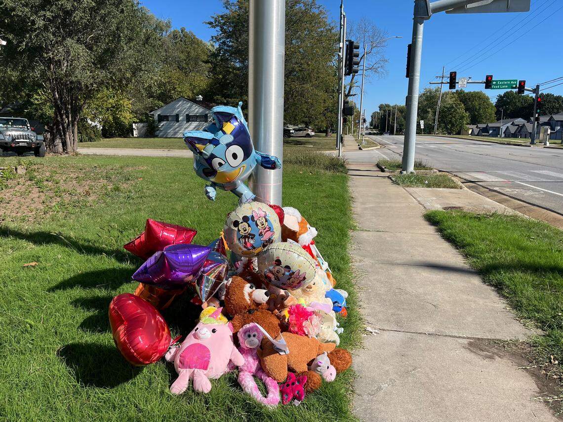 Flowers, notes, toys and balloons placed at a light post at the intersection where 3rd-grader Hazen Workman-Duffy was killed while biking to school.