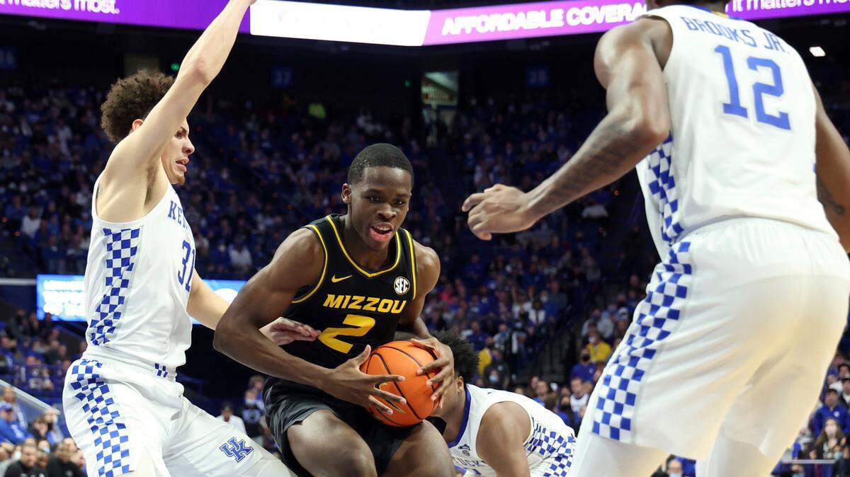 Missouri’s Sean Durugordon (2) looks for an opening between Kentucky’s Kellan Grady, left, and Keion Brooks Jr. (12) during the second half of an NCAA college basketball game in Lexington, Ky., Wednesday, Dec. 29, 2021. Kentucky won 83-56. (AP Photo/James Crisp)
