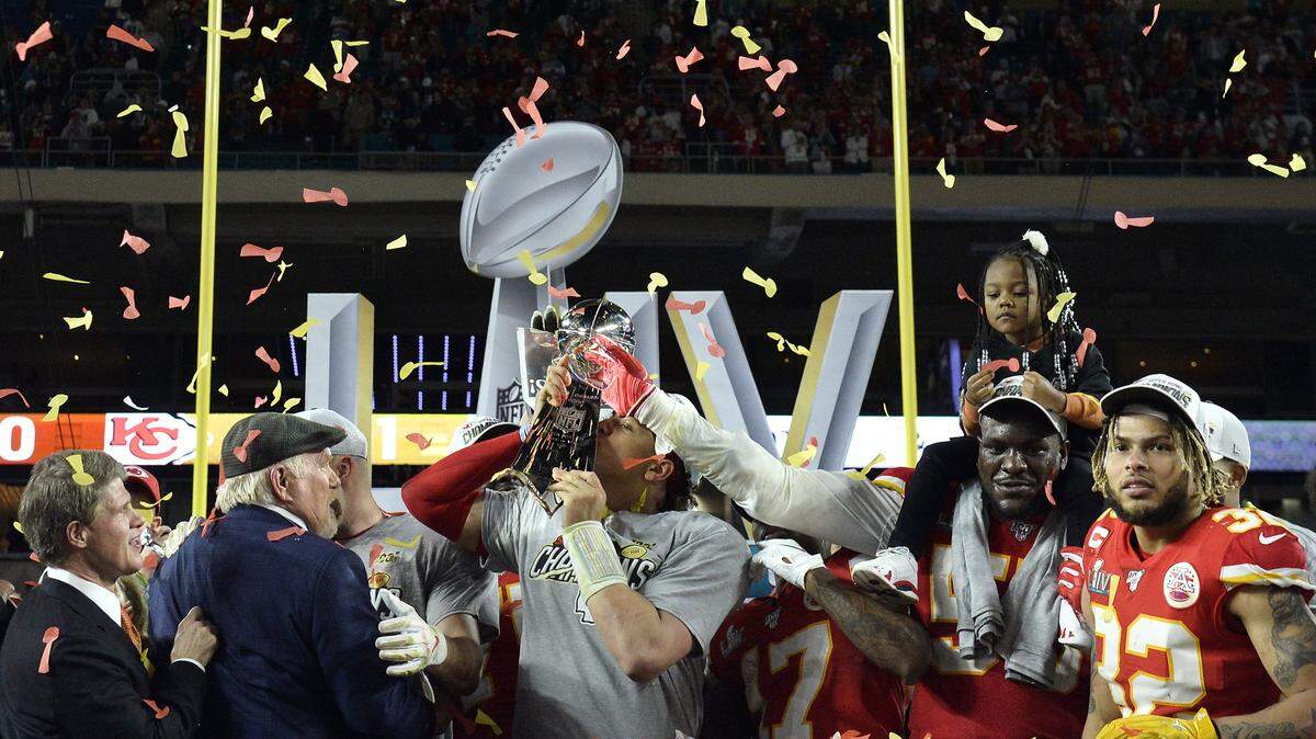 Kansas City Chiefs quarterback Patrick Mahomes kisses the Vince Lombardi trophy after the Chiefs defeated the San Francisco 49ers 31-20 during Super Bowl 54 at Hard Rock Stadium in Miami Feb. 2, 2020. Defensive end Frank Clark helps hold up the trophy. Chairman Clark Hunt, from left, sportscaster Terry Bradshaw and safety Tyrann Mathieu, right, were also onstage during the celebration.