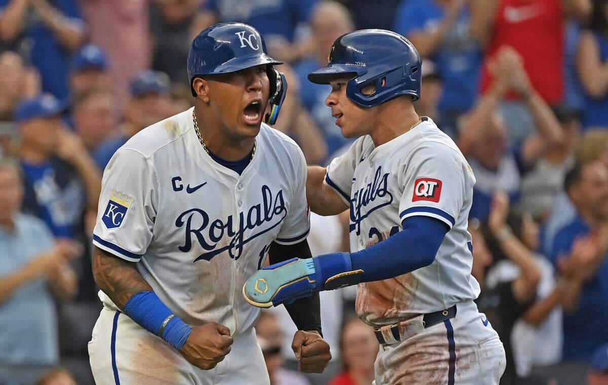 Kansas City Royals catcher Freddy Fermin (34) and Salvador Perez (13) react after scoring in the sixth inning against the Chicago Cubs at Kauffman Stadium.