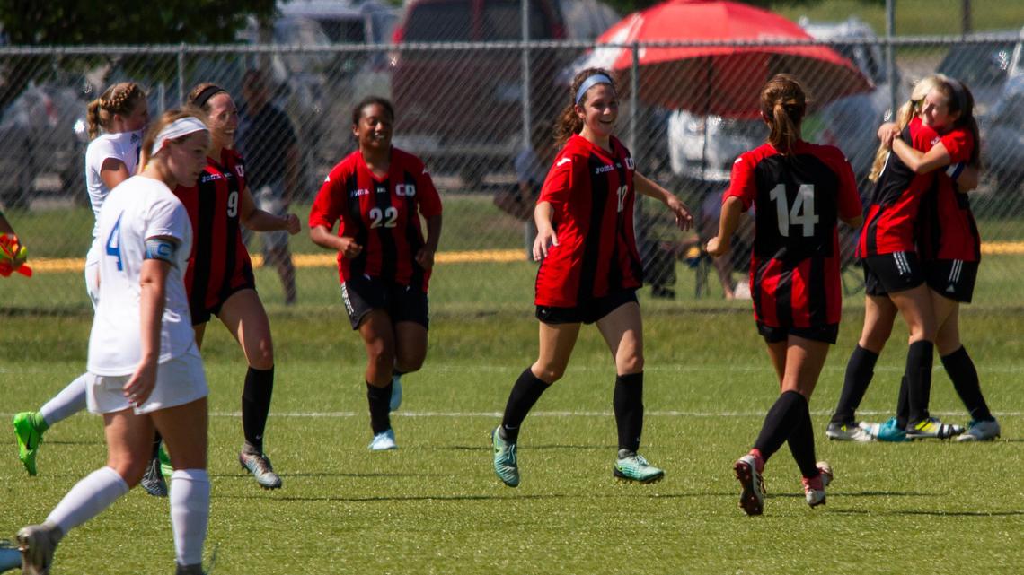 Andree Orcutt, center, and Blue Valley West teammates run toward Lindsi Banker after the final whistle on Saturday in Olathe.