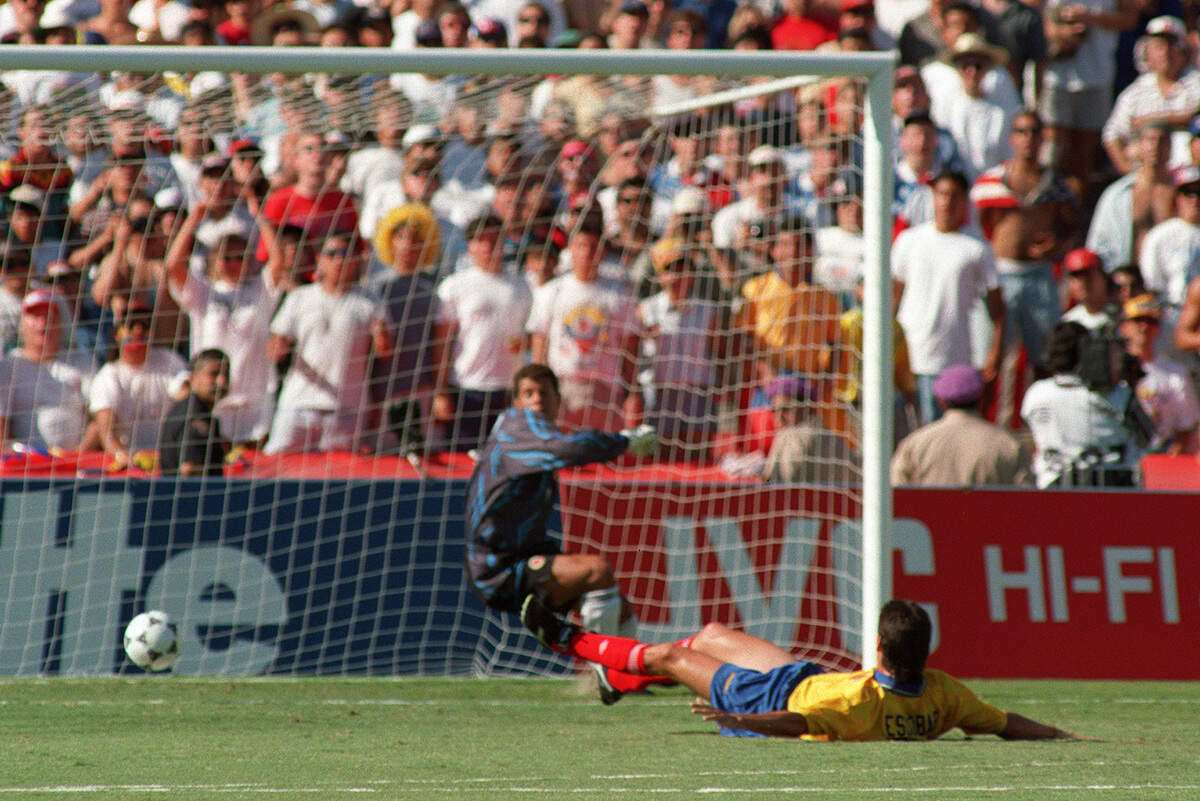 Colombian defender Andres Escobar lies on the ground after scoring an own goal past goalkeeper Oscar Cordoba while trying to stop a shot from U.S. forward John Harkes during a World Cup match between the United States and Colombia on June 22, 1994, in Los Angeles.