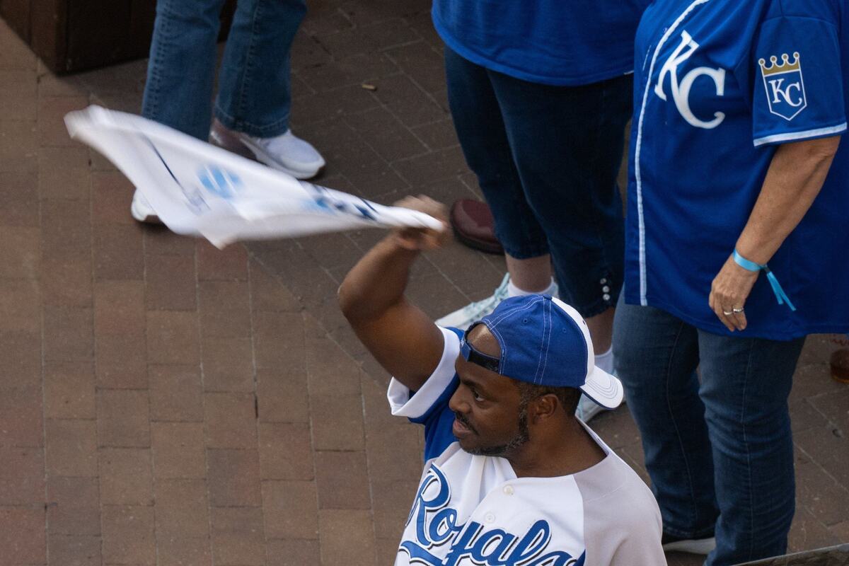 A fan waves a towel while watching the Royals opening playoff game vs. the Baltimore Orioles at the Power & Light District on Tuesday, Oct. 1, 2024. The Royals won the game 1-0.