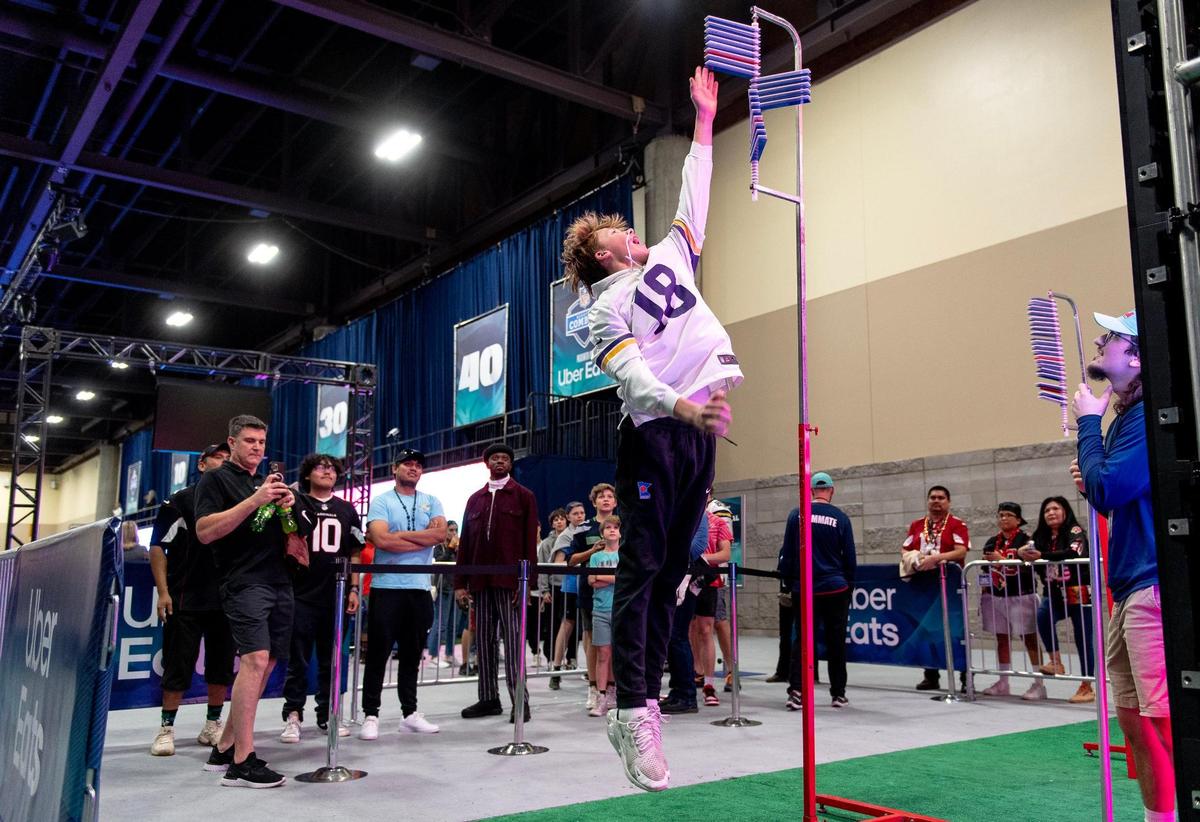 Bodey Mohr of Maple Grove, Minn., attempts a vertical jump test at the NFL’s Super Bowl Experience on Thursday, Feb. 9, 2023, in Phoenix.