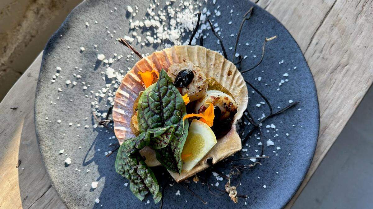Noka’s seared scallops with root vegetables and black garlic.