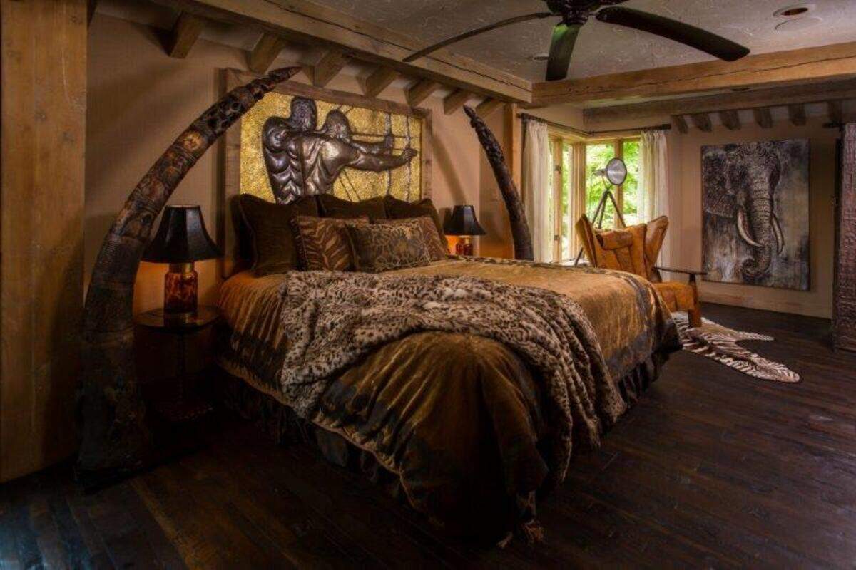 “It’s like having your own little oasis,” Michael Willhoit said of his Springfield home. “I’ve got something nobody else has got.” The tusk-like sculptures in this room are made of wood.