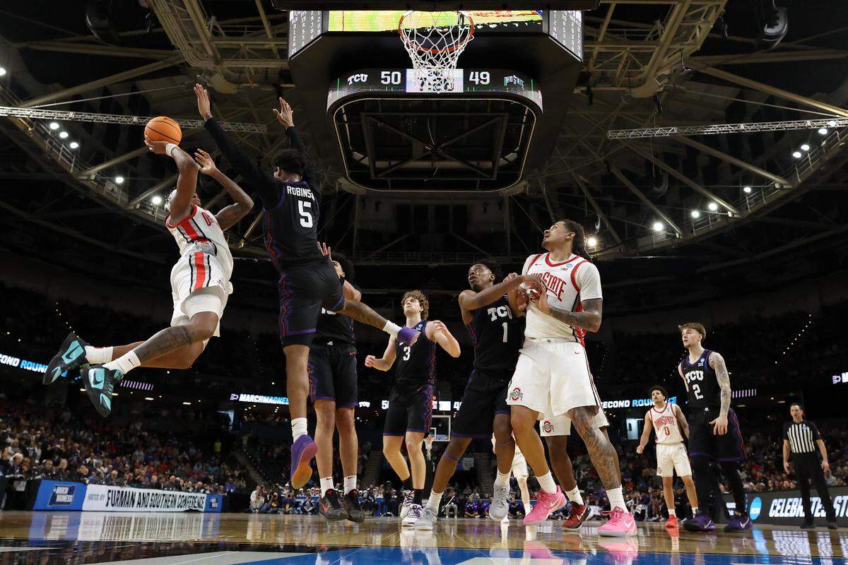 TCU’s Micah Robinson (No. 5) contests a shot by Ohio State’s Amare Bynum during a first-round NCAA Tournament game at Bon Secours Wellness Arena in Greenville, South Carolina on Thursday, March 19, 2026.