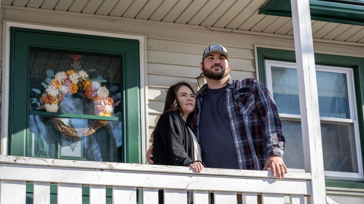 Carleigh and Greg Crossno stand for a portrait in their home on Sunday, March 9, 2025, in Blue Springs. The Crossnos have lived in their current home for two years after previously staying with Carleigh’s parents, facing challenges finding a home amid rising prices and competition from out-of-state investors acquiring thousands of properties in the Kansas City area.