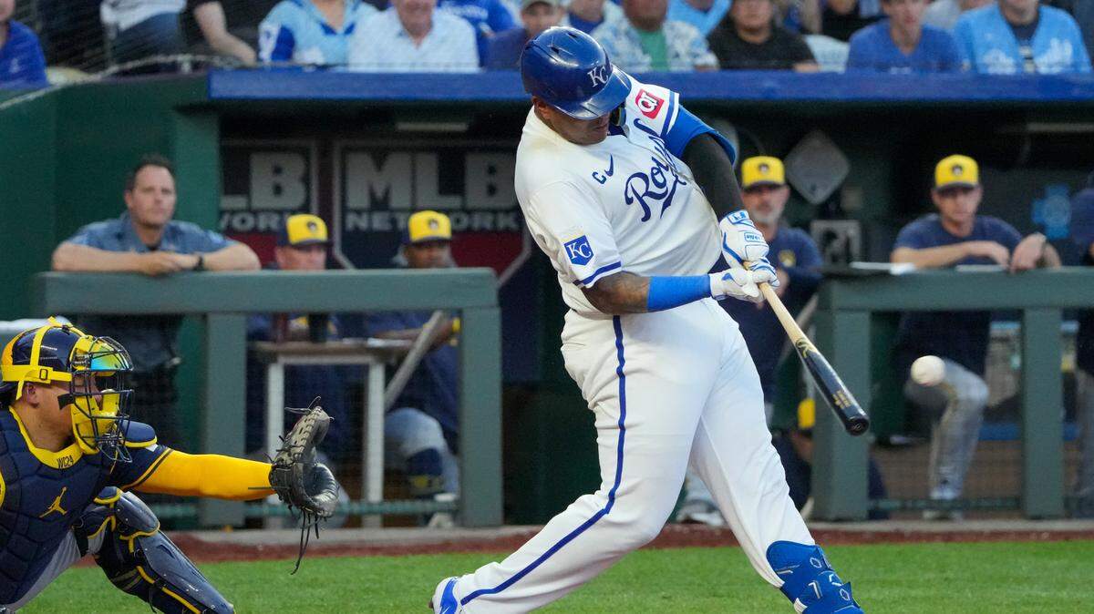 Kansas City Royals catcher Salvador Perez (13) hits a two-run double against the Milwaukee Brewers in the fifth inning at Kauffman Stadium.