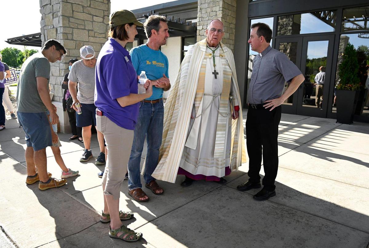 Archbishop Joseph Naumann of the Archdiocese of Kansas City in Kansas spoke with organizers before taking the stage at Value Them Both Tailgate and Rosary Rally in Overland Park.