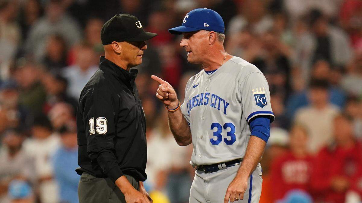 Kansas City Royals manager Matt Quatraro (33) talks with umpire Vic Carapazza (19) after a check-swing call against the Boston Red Sox in the ninth inning at Fenway Park on Aug. 7, 2023.