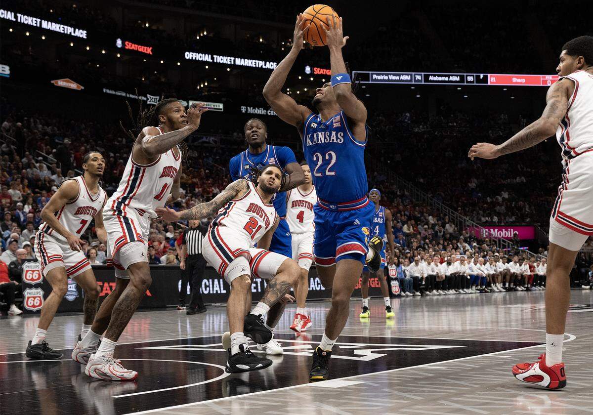 Kansas Jayhawks guard Darryn Peterson (22) can't get a shot off as the Houston Cougars defend in the first half at the Big 12 Men's Basketball Tournament at T-Mobile Center on Friday, March 13, 2026, in Kansas City.