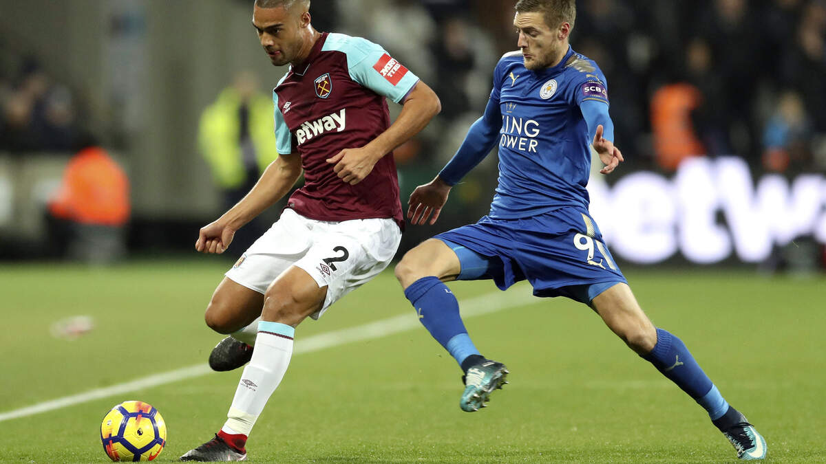 West Ham United’s Winston Reid, left and Leicester City’s Jamie Vardy vie for the ball, during the English Premier League soccer match between West Ham United and Leicester City, at the London Stadium, in London, Friday Nov. 24, 2017. (Adam Davy/PA via AP)