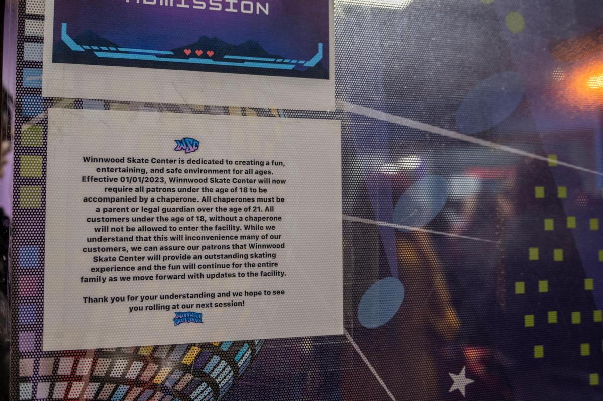 A mandatory signage is posted on the front entrance to Winwood Skate Center on Thursday, Jan. 12, 2023, in Kansas City. The sign informed visitors that all customers under the age of 18 would need a chaperone to enter the skating arena.