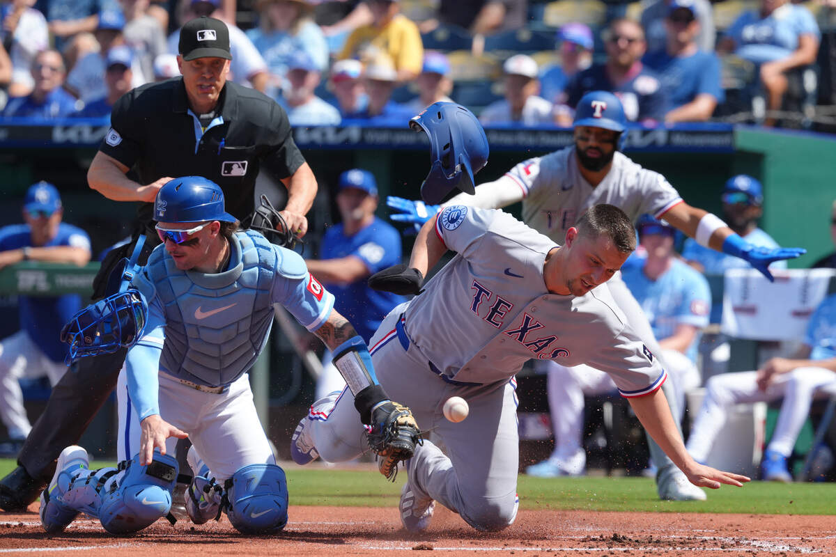Texas Rangers baserunner Corey Seager, right, collides with Royals catcher Carter Jensen during a game at Kauffman Stadium in Kansas City on Thursday, June 11, 2026.
