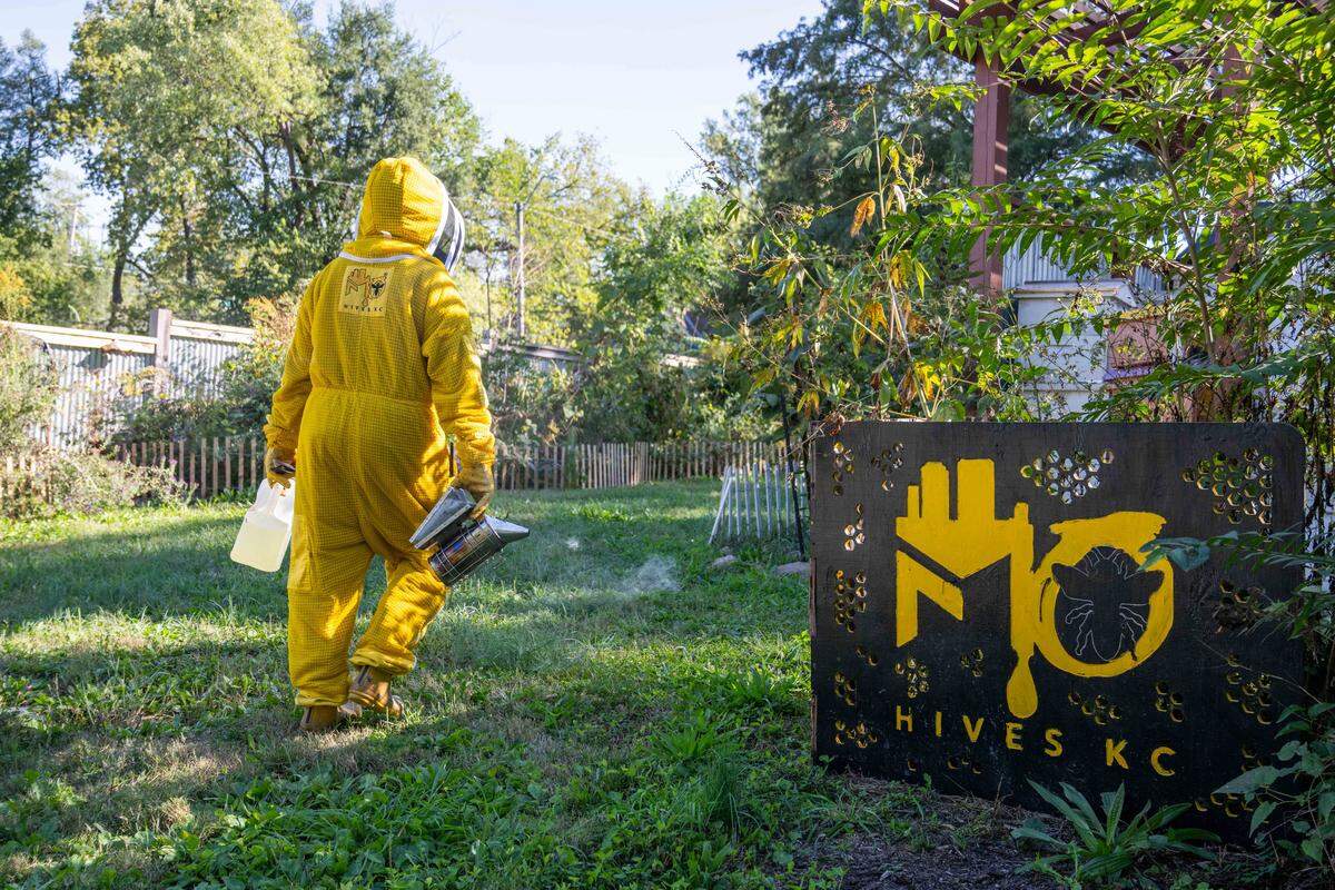 Charity Brown-Ritchie walks toward the bee hive area to perform maintenance on bee hives at MO Hives KC on Friday, October 10, 2025 in Kansas City. MO Hives places beehives onto vacant urban lots around the Kansas City metro area.