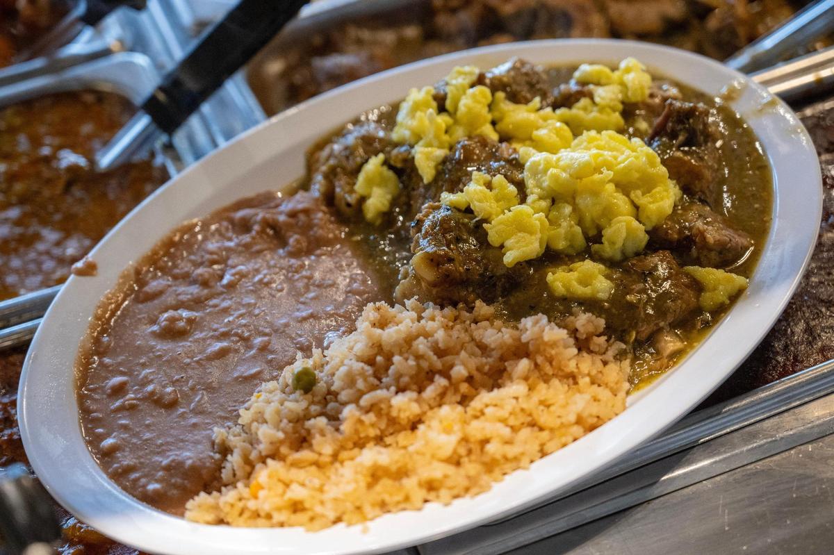 Breakfast at Los Alamos Cocina: pork ribs bathed in a green sauce, topped with eggs, rice and beans.