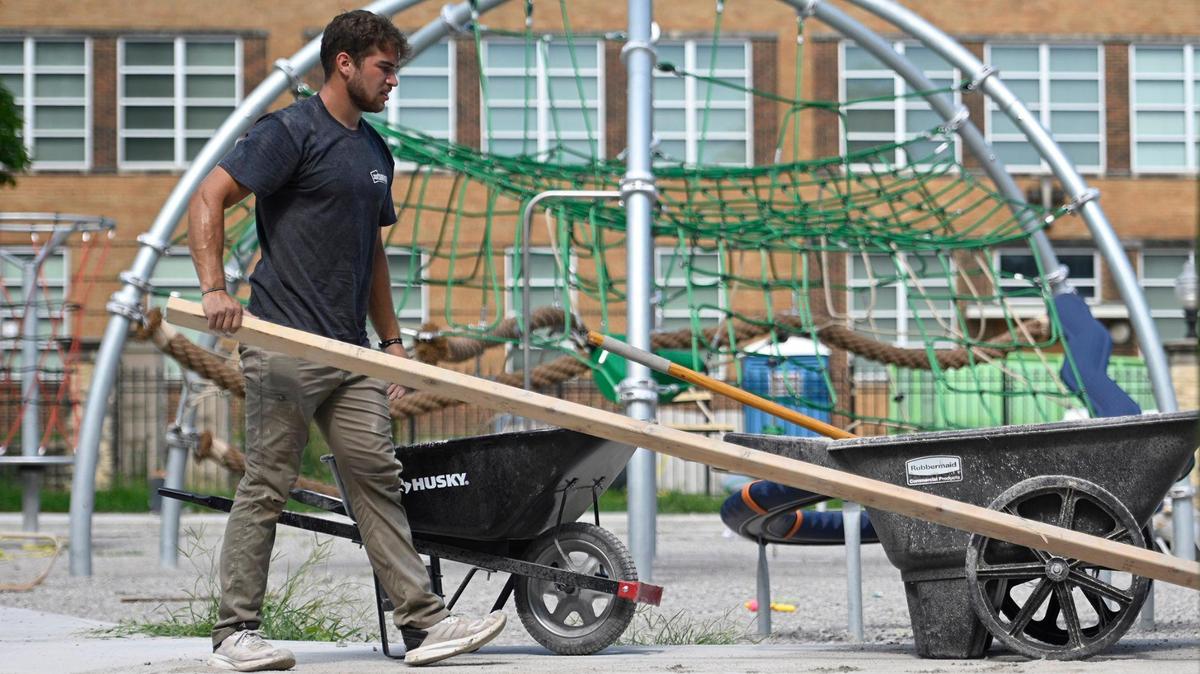 Working for sofSURFACES, a Canadian company that creates playgrounds, Cole Kramer of Clarksville, Iowa, worked in the heat on the new universally accessible playground being installed on July 15 Independence Plaza Park. Dangerouly hot conditions return this week in Kansas City.