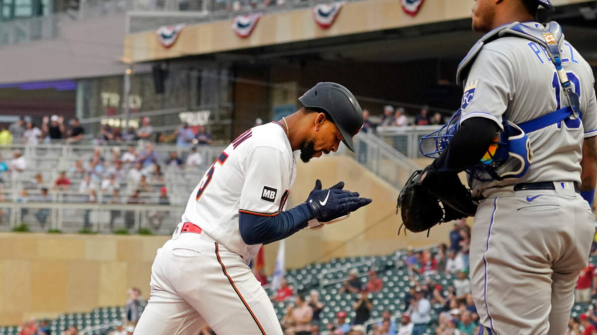 Minnesota Twins’ Byron Buxton (left) applauds in front of Kansas City Royals catcher Salvador Perez as Buxton scores on his solo home run off Royals pitcher Brady Singer in the first inning on Saturday, Sept. 11, 2021, in Minneapolis.